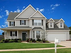 Elegant suburban home with modern architecture and lush landscaping.