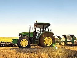 Farm tractor in field, agricultural insurance services from Norfolk Mutual.